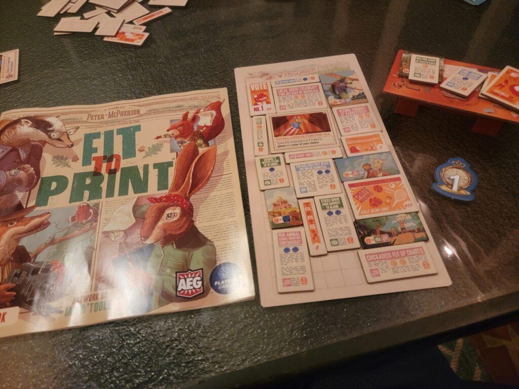 Fit to Print Board Game instructions on a table.